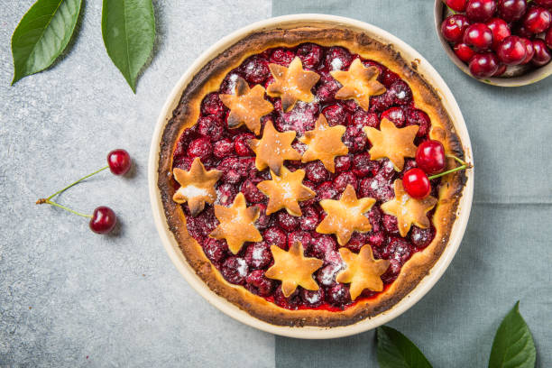 istock Homemade open cherry pie with frech cherries  on a gray concrete background. 1257072145
