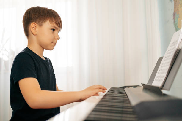 istock School boy playing synthesizer at home 1257072229