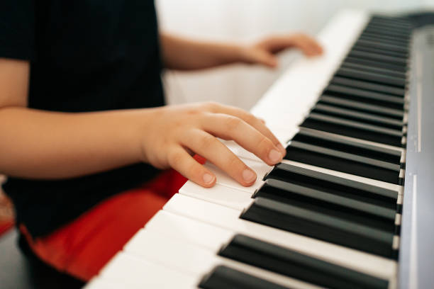 istock School boy hands playing synthesizer at home 1257072234