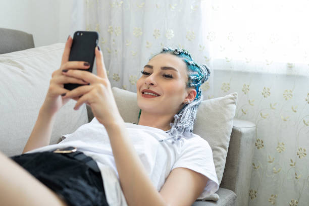 istock Young woman lying on sofa 1257073118