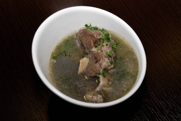 istock meat in the broth with some herbs served in the white bowl. side view 1257073209