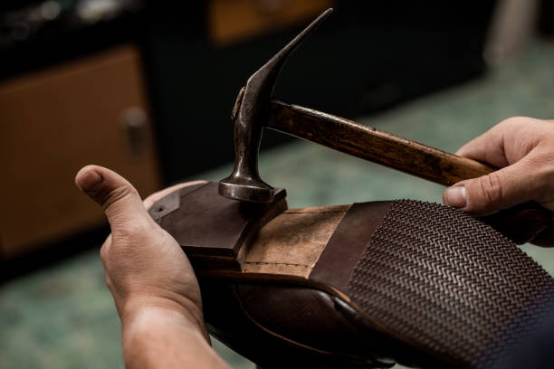 istock Cobler nailing shoe heel 1257073460