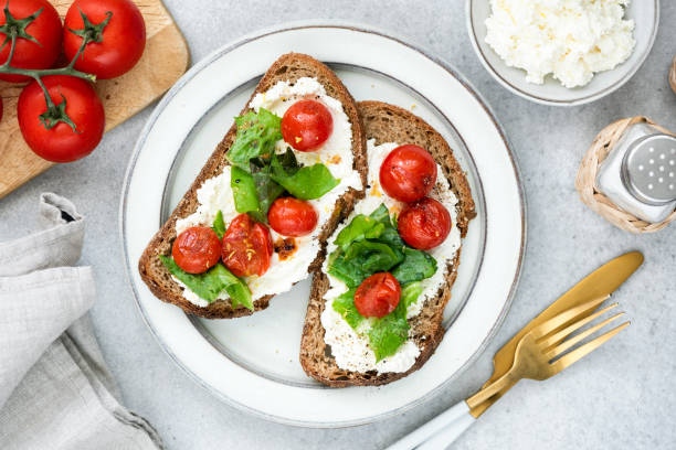 istock Bruschetta with ricotta cheese, roasted cherry tomatoes and chopped basil 1257074453