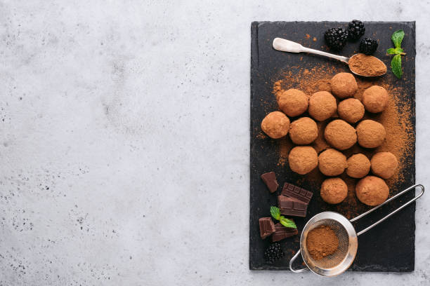 istock Homemade chocolate truffles on black slate background 1257074496