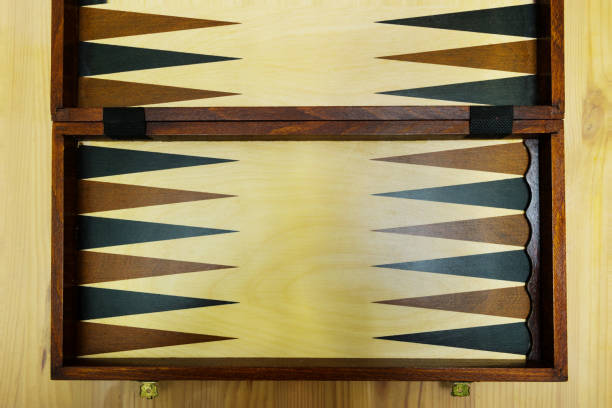 An old wooden backgammon Board on a wooden table. stock photo