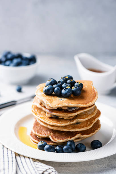 istock Stack of pancakes with blueberries and maple syrup 1257074551