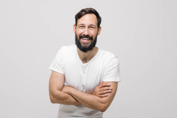 istock smiling happy young man in the studio on a white background 1257079702