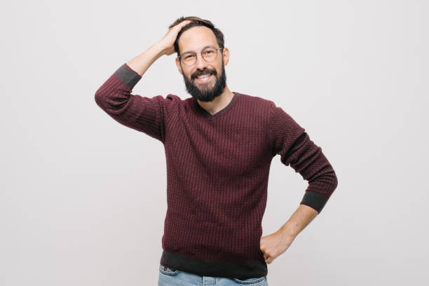 istock smiling young man in a burgundy sweater in the studio on a white background 1257079730