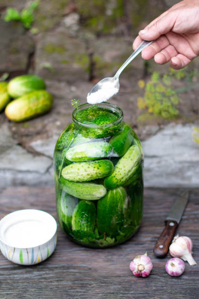 istock Salted cucumbers with spices and herbs in a glass jar 1257082607