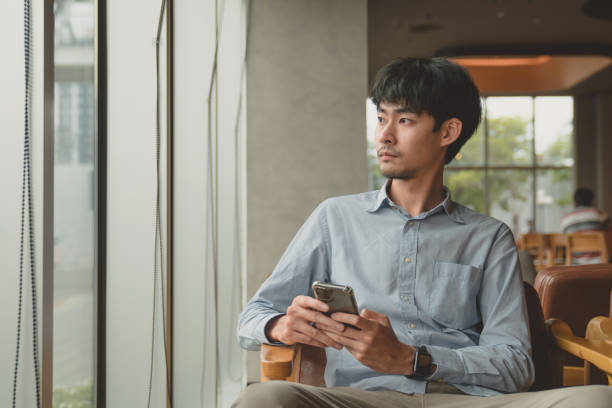 istock Casual man relaxed using smart phone in cafe 1257085451