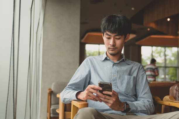 istock Casual man relaxed using smart phone in cafe 1257085463