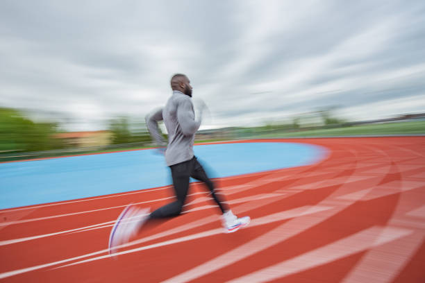 istock Young African American man running at tartan. 1257088556