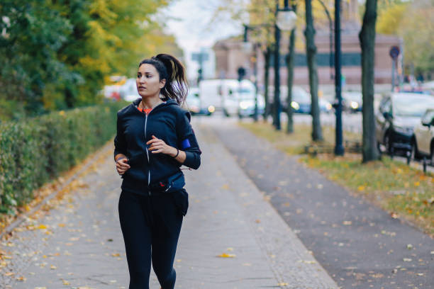 istock Young woman running in Berlin 1257091293