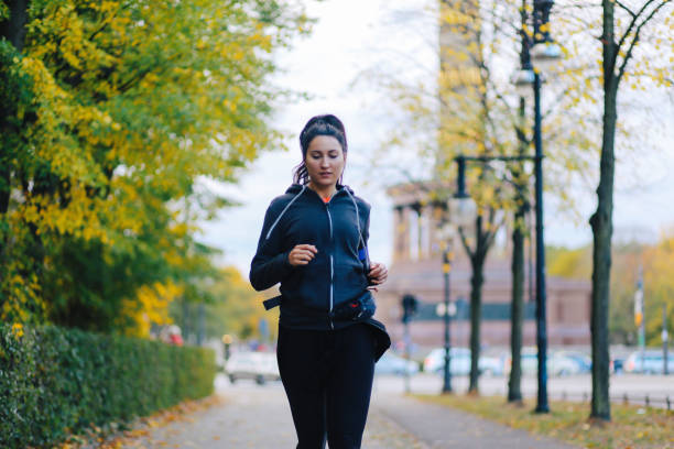 istock Young woman running in Berlin 1257091321