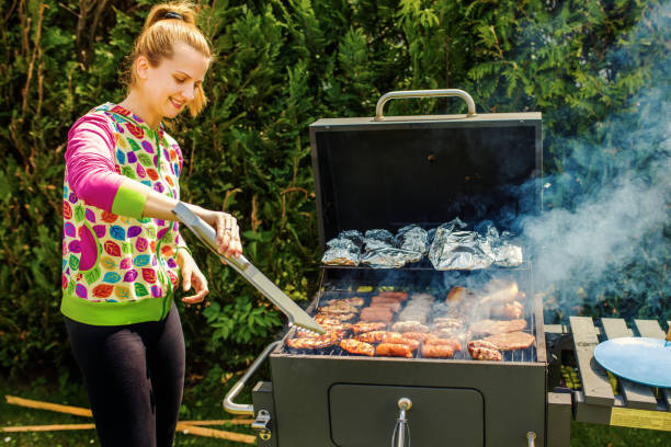 istock Woman At Barbecue In Backyard 1257092779