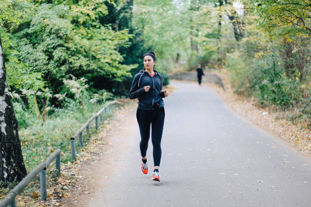 istock Young woman running in Berlin, Tiergarten park 1257092924
