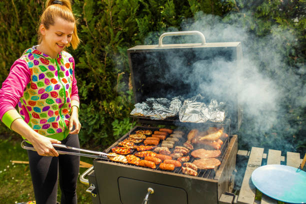 istock Woman At Barbecue In Backyard 1257093617