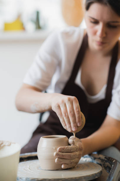 istock Master class on modeling of clay on a potter wheel In the pottery workshop 1257093907