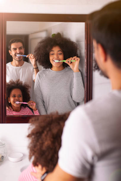 istock Young mixed family are brushing their teeth in the bathroom 1257095431