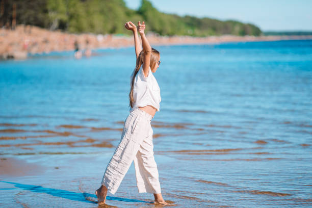 istock Young beautiful girl having fun on tropical seashore. 1257096613