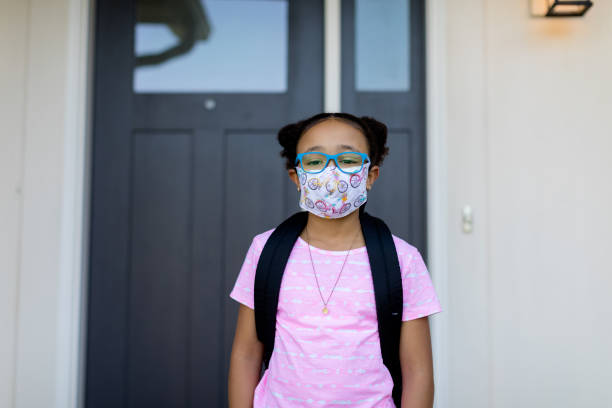 istock Young School Girl wearing Face Mask 1257097198