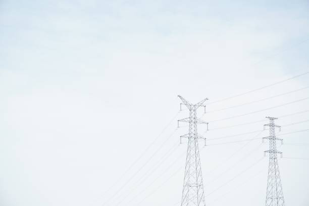 istock Low-angle view of two power towers and power lines with copy space 1257098158