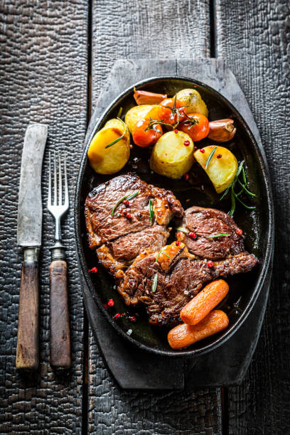 istock Roasted steak with vegetables and fresh herbs 1257102281