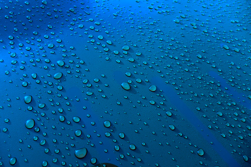 close up shot of rain drops on metal surface
