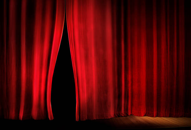 istock opening close up red stage curtain 1257104145