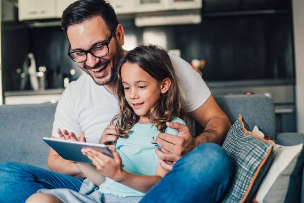 istock Father and daughter using tablet at home. 1257105719