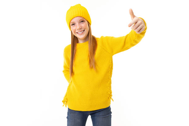 istock Red-haired European girl shows a class on a white background 1257108264