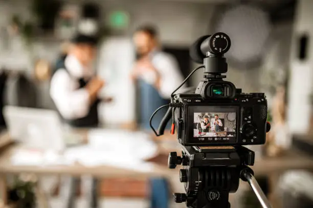 Two Fashion Designers Filming Fashion Internet Podcast in Fashion Design Studio