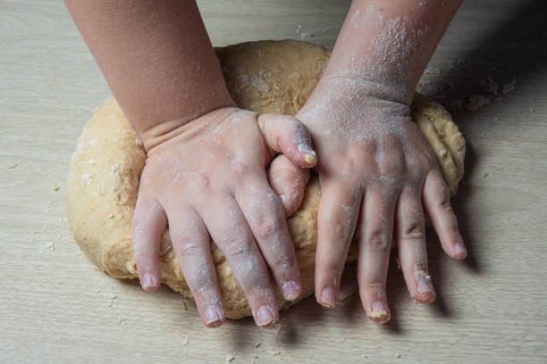 istock kneading homemade bread with flour on wooden table, selective focus. 1257109741