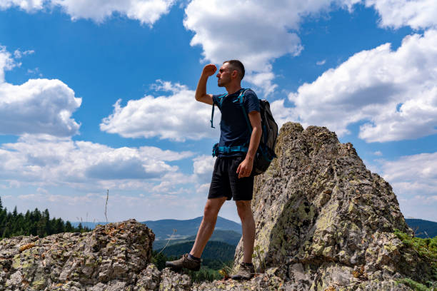 istock Traveler Man with backpack jumping hands raised mountains landscape on background Lifestyle Travel happy emotions success concept summer vacations outdoor 1257109928