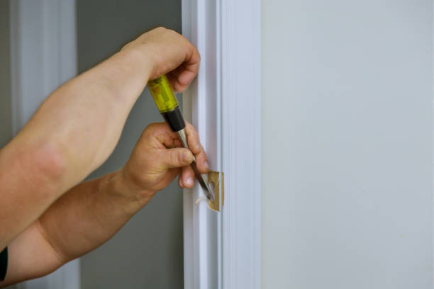 istock Carpenter working using a chisel with hole wooden door on a lock is installing the doors 1257110963
