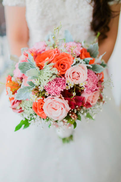 istock Bride holding a beautiful wedding bouquet flower arrangement. 1257112007