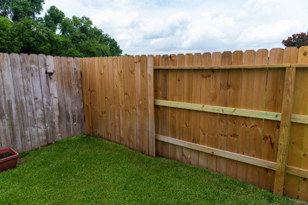 istock Wooden privacy fence, new and old in the same yard 1257113621