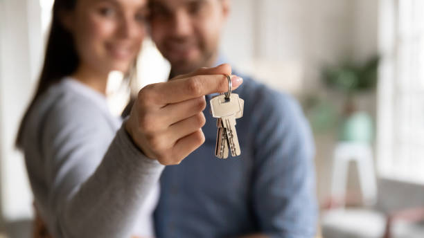 Close up happy young woman hugging man, holding keys Close up happy woman hugging man, holding keys from new first house, young family celebrating moving day, satisfied customers couple purchase real estate, mortgage and relocation concept house key photos stock pictures, royalty-free photos & images