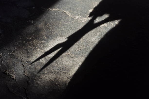 istock man's shadow using scissors. photo illustration of a psychopathic killer 1257118635