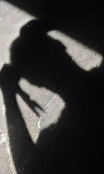 istock man's shadow using scissors. photo illustration of a psychopathic killer 1257118760