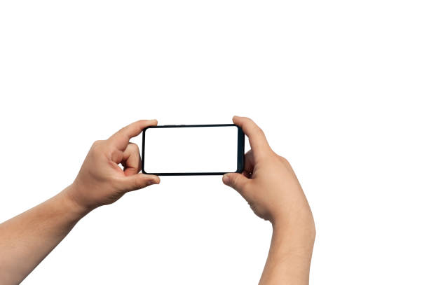 istock Man hand on white background holds phone with isolated screen. Mockup Technology. 1257119463