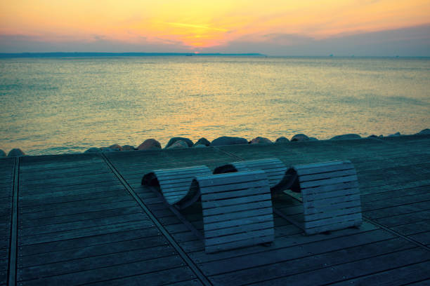 istock Comfortable sun loungers on the northern beach 1257124013