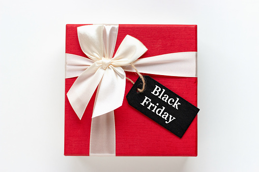 Red gift box with Black Friday inscription on a white background copy space