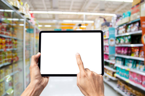 istock man hand using tablet on Supermarket blur background, Online shopping concepts 1257129436