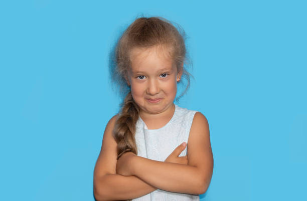 istock Mischievous little gir with curly hairl making sarcastic face, like seriously 1257130528