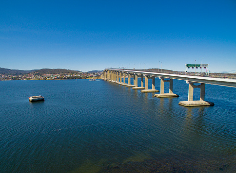 Aerial view of Hobart's iconic Tasman Bridge with the MONA ferry.