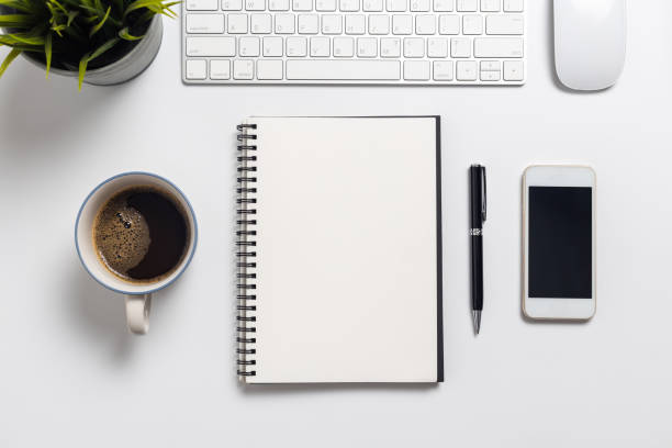istock Top view, empty notebook and office supplies on the desk. 1257132418