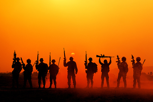 The silhouette of a military soldier with the sun as a Marine Corps for military operations