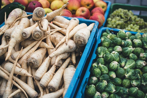 A wooden crate is filled with fresh, colorful organic vegetables.