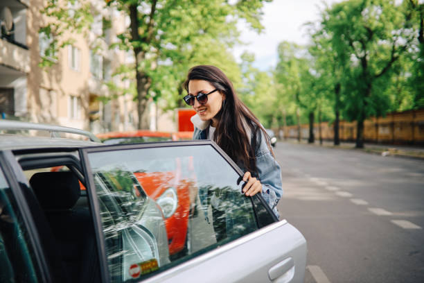 Young woman taking a car share ride on the streets of Berlin Young woman taking an Uber ride in Berlin, Germany. car pooling stock pictures, royalty-free photos & images